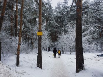 People walking on snow covered field