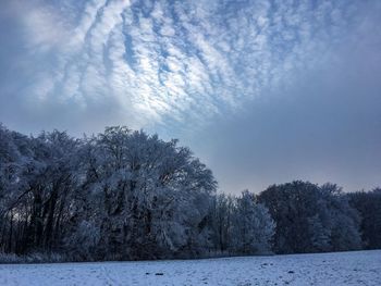 Scenic view of snow covered land against sky