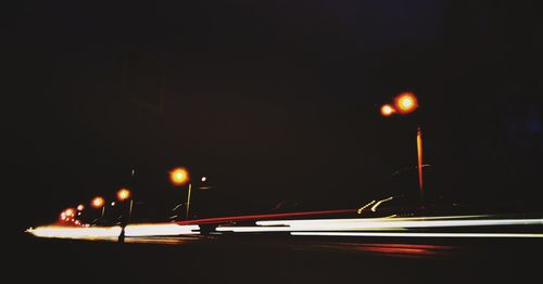 Cars on illuminated street at night