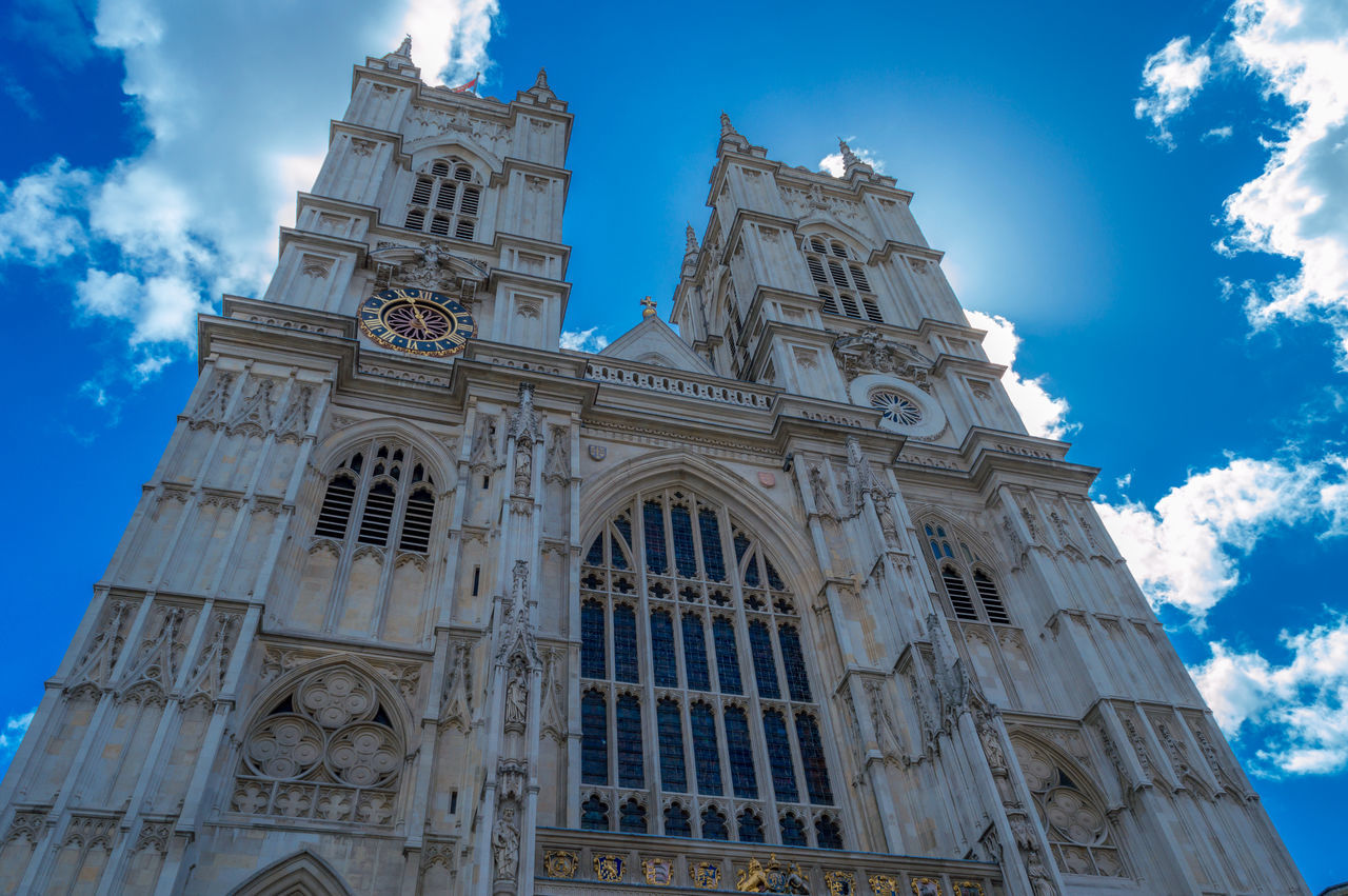 low angle view, architecture, built structure, building exterior, religion, place of worship, church, blue, sky, spirituality, cathedral, famous place, tower, history, travel destinations, cloud - sky, day, cloud