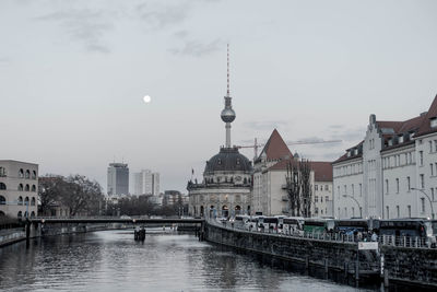 Bridge over river with buildings in background