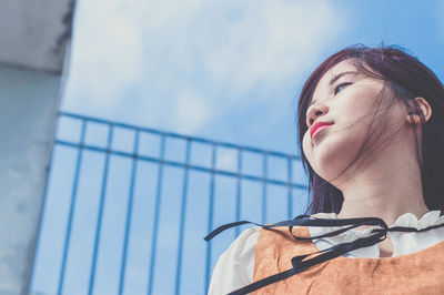 Low angle view of woman against sky