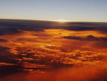 Aerial view of clouds over landscape during sunset