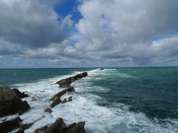 Scenic view of sea against cloudy sky