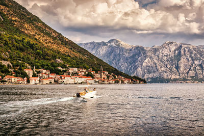 Scenic view of sea and mountains against sky