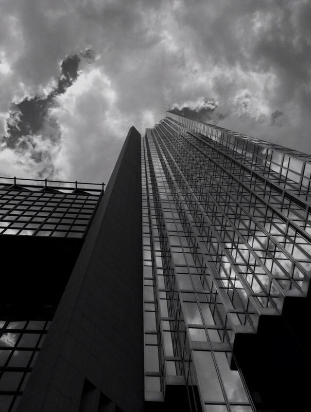 architecture, built structure, building exterior, low angle view, sky, modern, cloud - sky, city, office building, cloudy, skyscraper, building, tall - high, cloud, tower, glass - material, day, outdoors, no people, tall