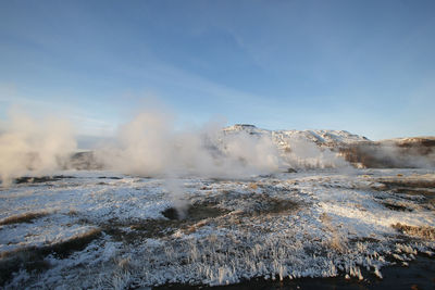 View of hot spring against sky during winter