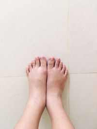 Low section of woman on tiled floor