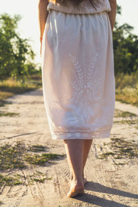 Close up barefoot woman walking on sand road concept photo