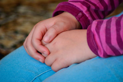 Close-up of baby feet on hand