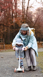Side view of woman with dog in forest