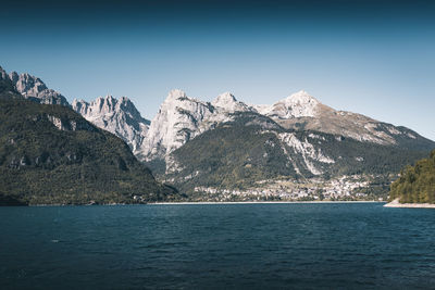 Scenic view of snowcapped mountains and sea against clear sky