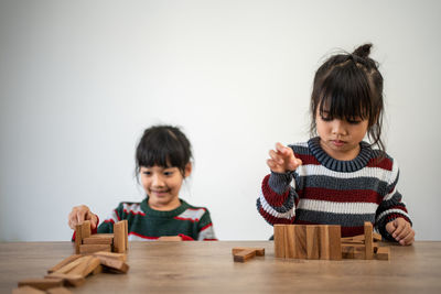 Mother playing with toy blocks at home