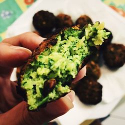 Close-up of cropped hand holding food