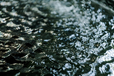 Full frame shot of raindrops on water