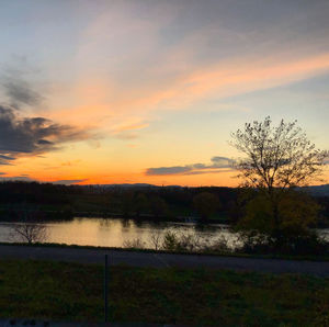 Scenic view of field against sky during sunset