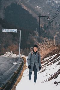 Full length of man standing on snow covered land