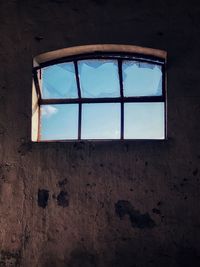Low angle view of window in abandoned building
