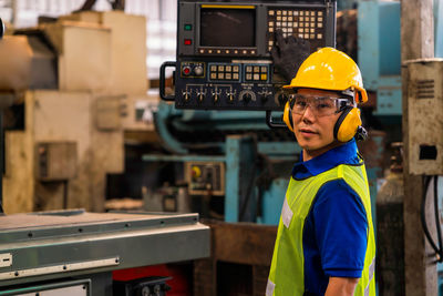 Portrait of man working in machine