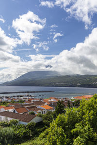 Scenic view of trees and buildings against sky