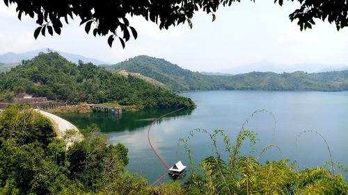 Scenic view of lake and mountains against sky