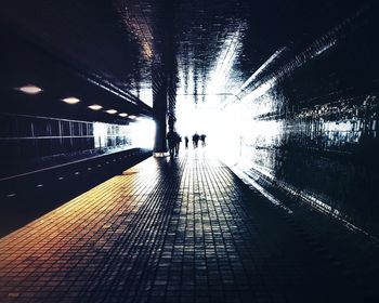 Man walking in illuminated tunnel