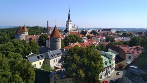 Buildings in town against clear sky