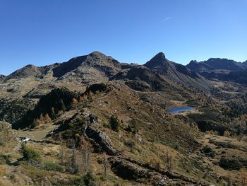 Scenic view of mountains against clear blue sky