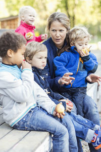 Teacher with children outside kindergarten