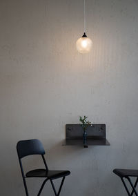 Electric lamp on table against wall at home