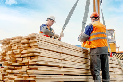 Rear view of man standing on wooden wall