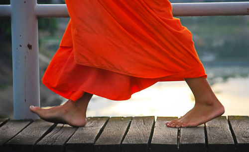 Low section of woman wearing red shoes