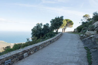 Road by sea against sky