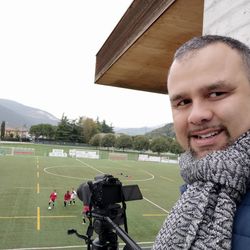 Portrait of smiling man on field against sky