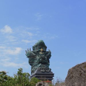 Low angle view of statue against cloudy sky