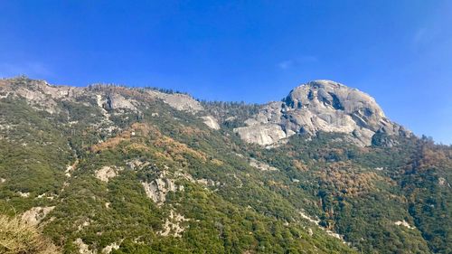 Scenic view of rocky mountains against clear blue sky