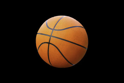 Close-up of basketball hoop against black background