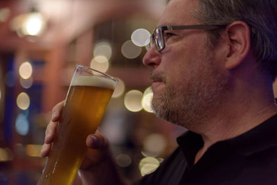 Man drinking beer from glass