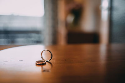 Close-up of wedding rings on table