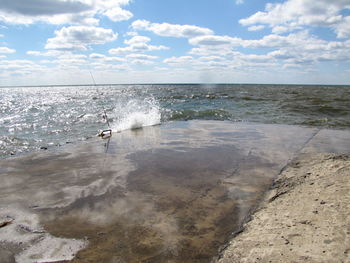 Scenic view of sea against cloudy sky