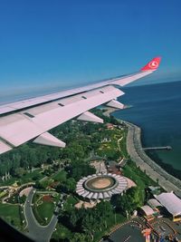 High angle view of airplane flying in city against sky