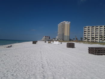 Scenic view of beach against clear sky during winter