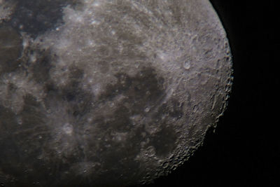 Close-up of moon over water against sky