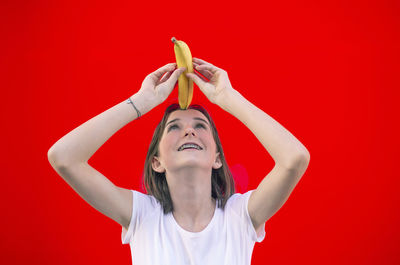 Midsection of woman holding red umbrella