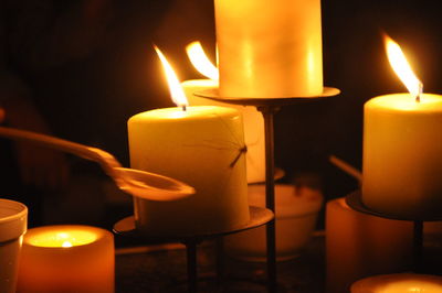 Close-up of lit candle in dark room