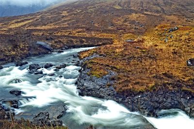 Aerial view of stream flowing through rocks