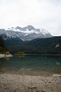 Scenic view of lake and mountains against sky