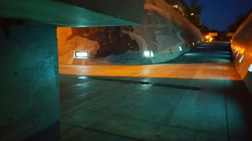 Illuminated tunnel at night