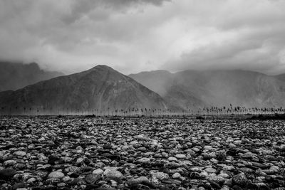 Scenic view of mountains against cloudy sky