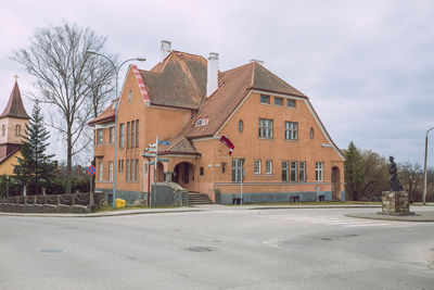 Road by building against sky